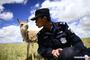 Auxiliary police officer Xie Ancheng plays with a Tibetan antelope at a conservation station in Hoh Xil in Yushu Tibetan Autonomous Prefecture, northwest China's Qinghai Province, Aug. 15, 2017. China's annual political sessions of the National People's Congress (NPC) and the National Committee of the Chinese People's Political Consultative Conference (CPPCC) are scheduled to convene in March, 2018. During the two sessions, development agendas will be reviewed and discussed, and key policies will be adopted. Year 2018 marks the first year of fully implementing the spirit of the 19th National Congress of the Communist Party of China, which vowed to pursue the vision of innovative, coordinated, green, and open development that is for everyone. The CPC congress stressed that building an ecological civilization is vital to sustain the Chinese nation's development, 