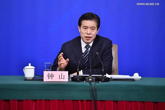 Chinese Minister of Commerce Zhong Shan answers questions at a press conference on opening up on all fronts and promoting high quality development of commercial business on the sidelines of the first session of the 13th National People&#39;s Congress in Beijing, capital of China, March 11, 2018. (Xinhua/Li Xin)
